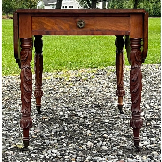 Stunning antique American Federal drop leaf table. Solid mahogany with well shaped top and exquisite acanthus carved legs....