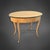 Oval side table from the Biedermeier period, circa 1825. The tabletop is cherry veneered and framed by an ebonized border...