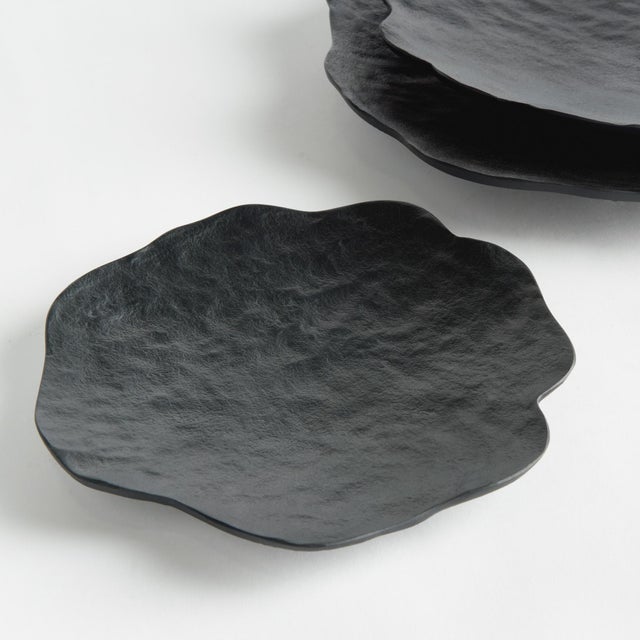 This set of 3 handcrafted bowls has simple, floralinspired silhouettes, with a matte finish and hammered texture. They can...