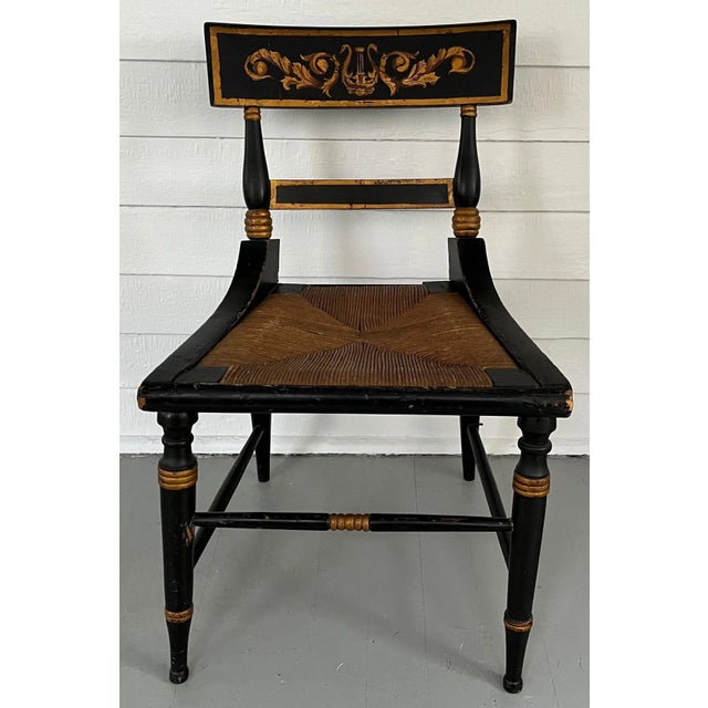 Antique 19th century American Classical paint decorated side chair with tablet back and outswept legs. Decorated with a...