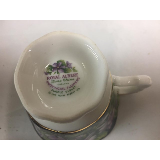 Marked "Royal Albert Bone China England, Provincial Flowers Purple Violets, 1975, Royal Albert LTD", this lovely eighteen...