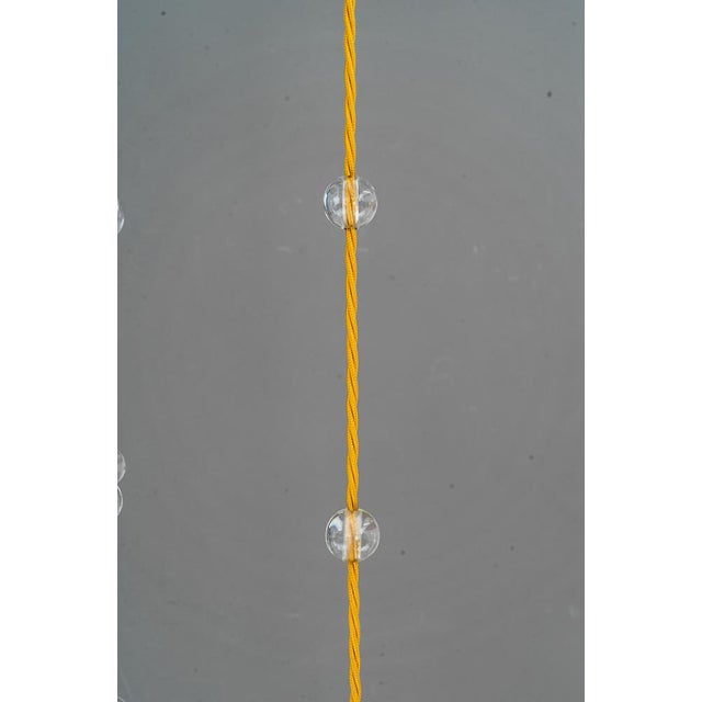 Jugendstil chandelier vienna around 1910. Brass polished and stove enameled.The wires are replaced (new). The glass balls...