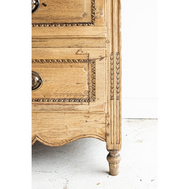 Fabulous 18th century bleached commode with 3 carved drawers featuring stunning floral details and beautiful hardware. The...