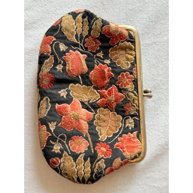 Vintage mid-century floral brocade coin purse featuring a richly woven black textile ground embellished with raised...