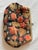 Vintage mid-century floral brocade coin purse featuring a richly woven black textile ground embellished with raised...