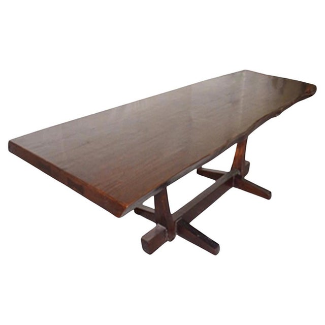 Impressive live edge three inch thick reclaimed teak wood dining table set on a modern teak base. Polished with a dark...