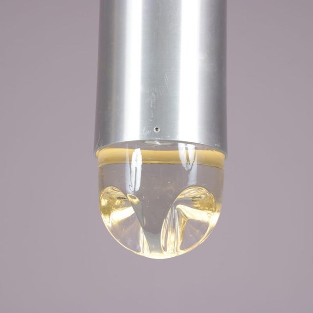 A beautiful “bullet” hanging lamp, manufactured by raak in the netherlands in the 1960s. This unique lamp has a cylinder...