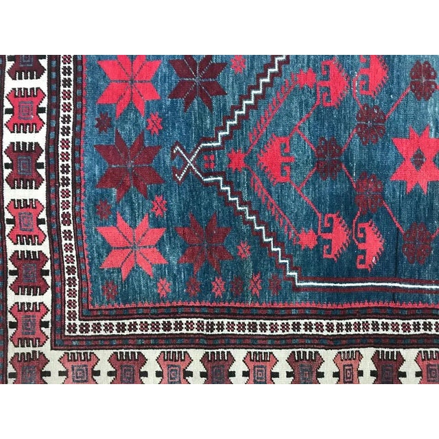 A beautiful 20 century Turkish rug with a geometrical medallion design and nice colors with blue, pink and purple,...