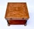 A two tier book- matched flame grain Walnut side table with one drawer showcasing Neoclassical design elements in the...