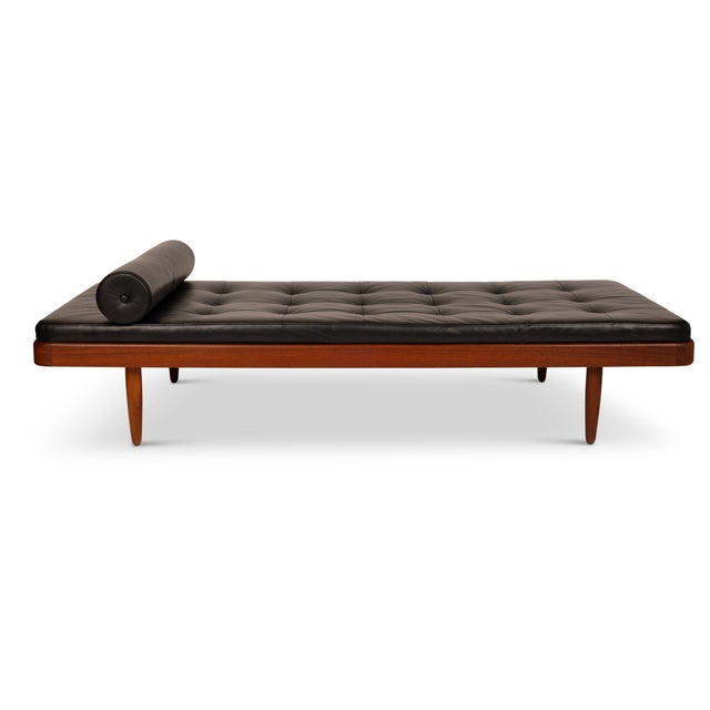 This stunning vintage Danish mid-century modern teak daybed has been expertly reupholstered in luxurious black leather by...