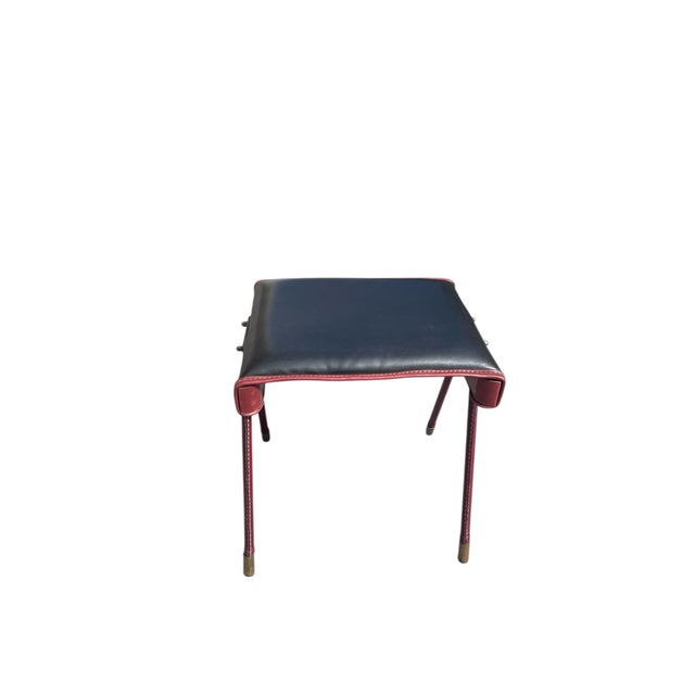 A Rare French Midcentury Modern hand stitched leather fire ottoman by Jacques Adnet, circa 1955. Adnet had a rare talent...