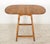 Vintage Traditional style end table in medium tone wood, with a drop leaf top and turned legs with low stretchers. There...
