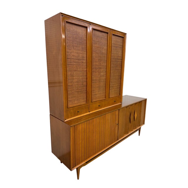 Elevate your space with this striking Mid-Century Modern Walnut & Cane 2-Piece Tambour Hutch, circa 1960s. Beautifully...