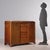 Mahogany chest of drawers, front with four drawers enclosed by a pair of doors, bracket feet, brass details. Italy,...