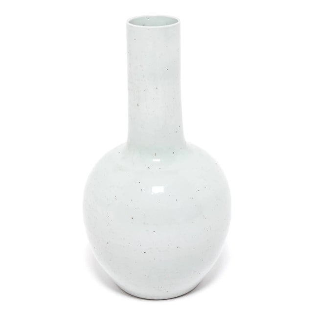 Drawing on a long Chinese tradition of monochrome ceramics, this tall gooseneck vase is glazed in serene pale celadon. The...