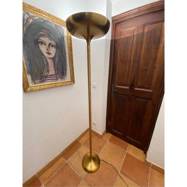 Halogen floor lamp with minimalist design and rounded curves. In gold metal (brass color) from Italian manufacture....