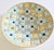 A colorful blue and yellow geometric design ceramic tile bowl. tiles are hand laid into a metal gold anodized aluminum...
