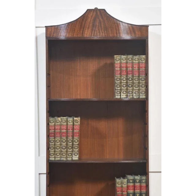 A fine quality antique mahogany bookcase, beautifully crafted with elegant proportions. The piece features a shaped...