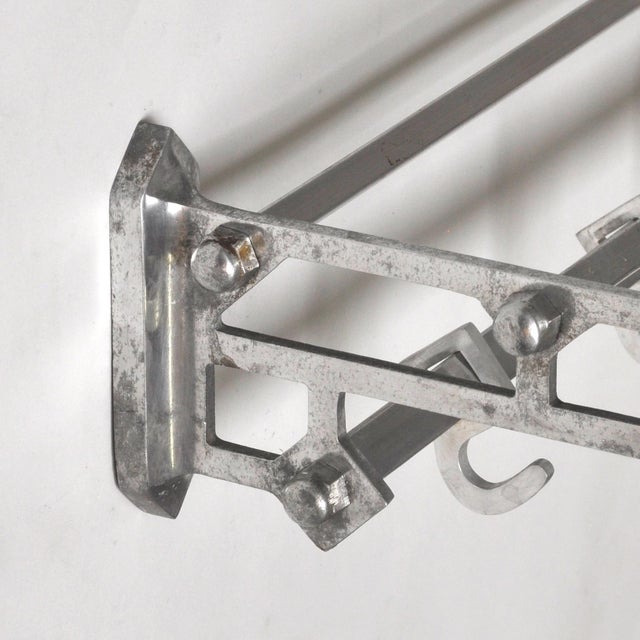Vintage aluminum coat rack from the 1950s, featuring a distinctive industrial design. The lightweight yet sturdy frame is...