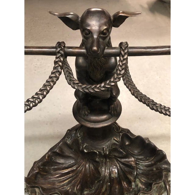A well casted bronze dog form umbrella stand or cane holder with lily pad form base after the original by Coal Brookdale.