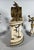 A Louis XVI style mantel clock and floral candelabra set. The mantel clock features four white marble columns on a blue...