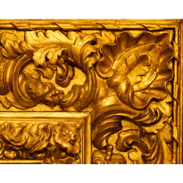 An important carved wood frame, water-gilded in gold leaf over red bole, attributable to the production of Central Italy...