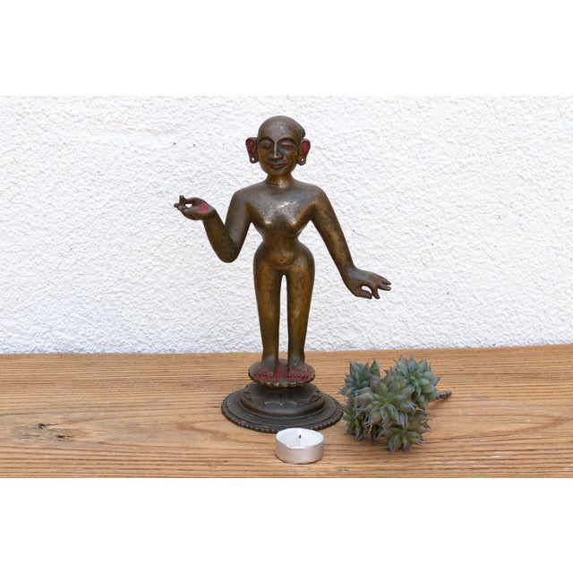 A striking historical masterpiece of traditional lost-wax casting, showcasing fluid tribal contours, a rich multi-toned...