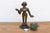 A striking historical masterpiece of traditional lost-wax casting, showcasing fluid tribal contours, a rich multi-toned...