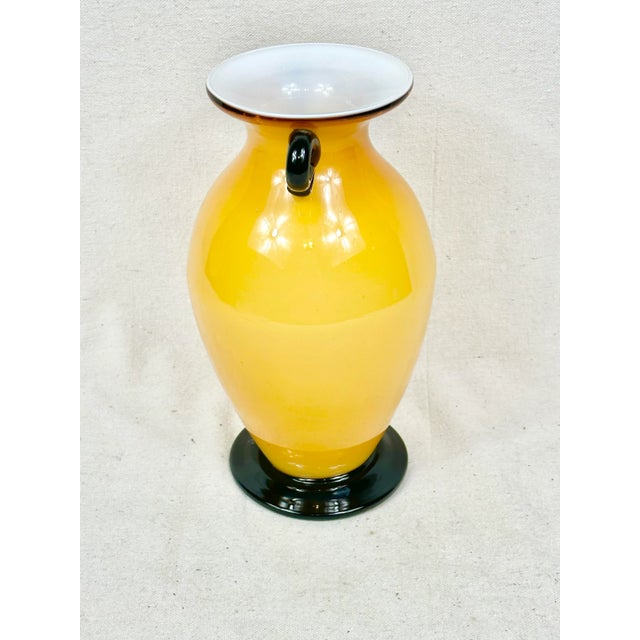 Gorgeous vintage glass vase. Murano style. Yellow orange coloring with black accents. Perfect to use for display or for a...