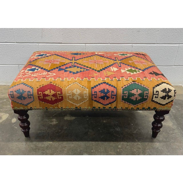 George Smith Standard ottoman in colorful kilim on turned mahogany legs.