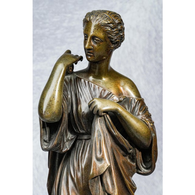 This exquisite bronze statue is a refined representation of the Diana of Gabii, depicting Artemis, the Greek goddess of...
