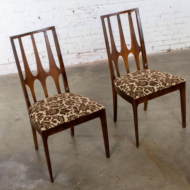 Handsome vintage pair of Mid Century Modern Broyhill Brasilia dining or side chairs composed of walnut frames with...