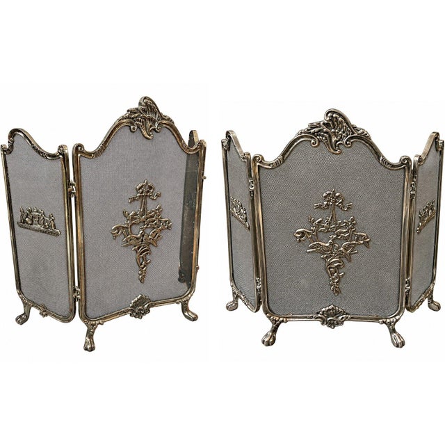 Elegant vintage three-panel folding fireplace screen featuring intricate Rococo-inspired metalwork, fine mesh panels, and...