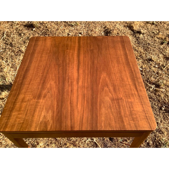 A lovely walnut occasional table designed by Stewart McDougall and Kipp Stewart for Drexel's Declaration collection,...