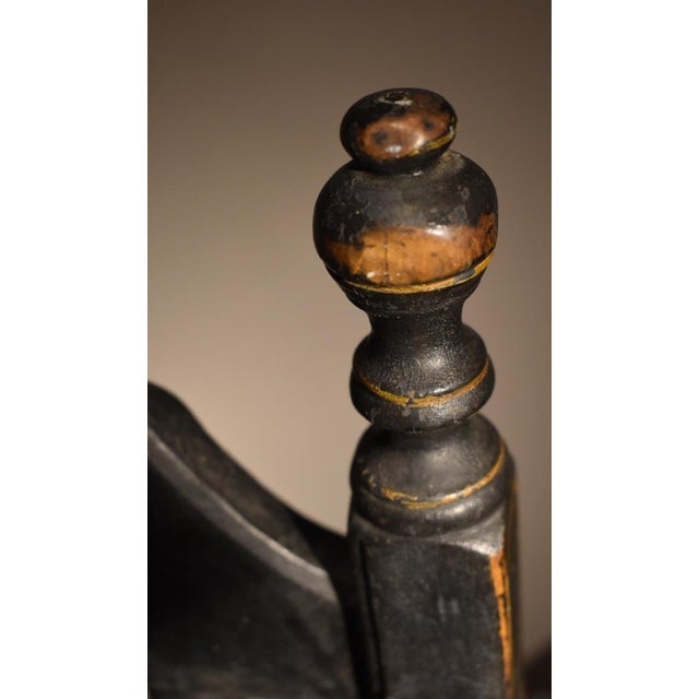 New England banister back chair, Circa 1710-50, is in wonderful crazed old black paint with gilt pinstriping to accentuate...