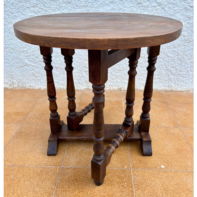 Antique English oak table from the 20th century, crafted in the Jacobean Revival style. The piece features turned legs...