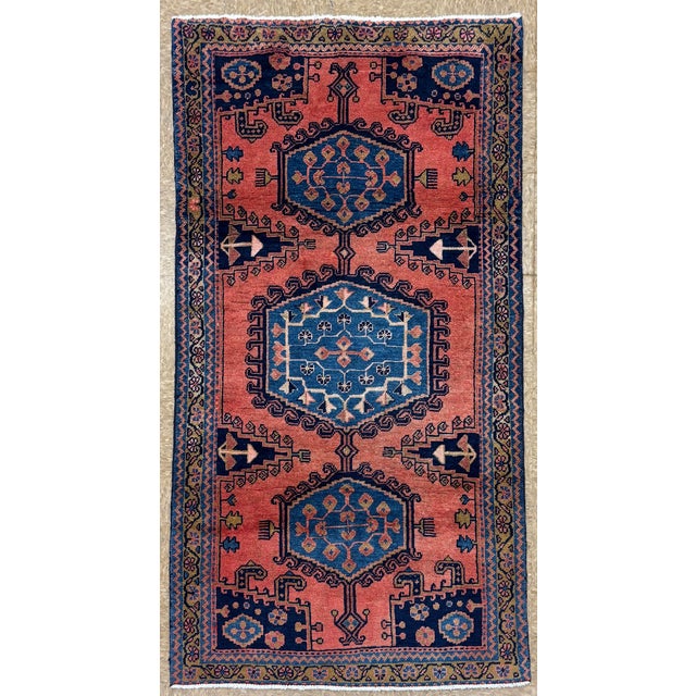 Hand-knotted village runner from the Wiss (Viss) area near Arak in western Iran, featuring a series of three large...