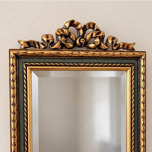 Vintage Belgian full length mirror with an ornate gold wood frame, beveled glass and an elegant decorative crest. Made in...