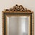 Vintage Belgian full length mirror with an ornate gold wood frame, beveled glass and an elegant decorative crest. Made in...