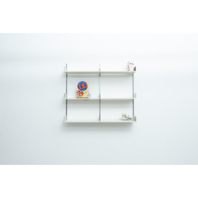 Modular shelving system 606, designed by Dieter Rams. Consisting of three aluminum E-profile rails and six wooden shelves....