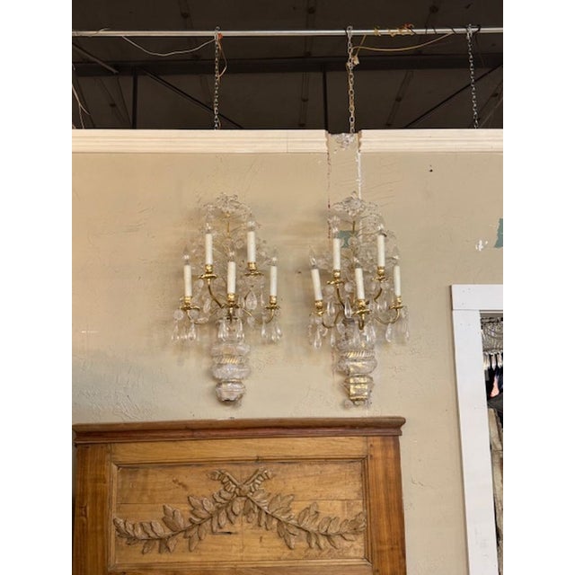 Fine pair of Maison Bagues manner gilt brass and rock crystal wall sconces. Circa 2000. The sconces have been...