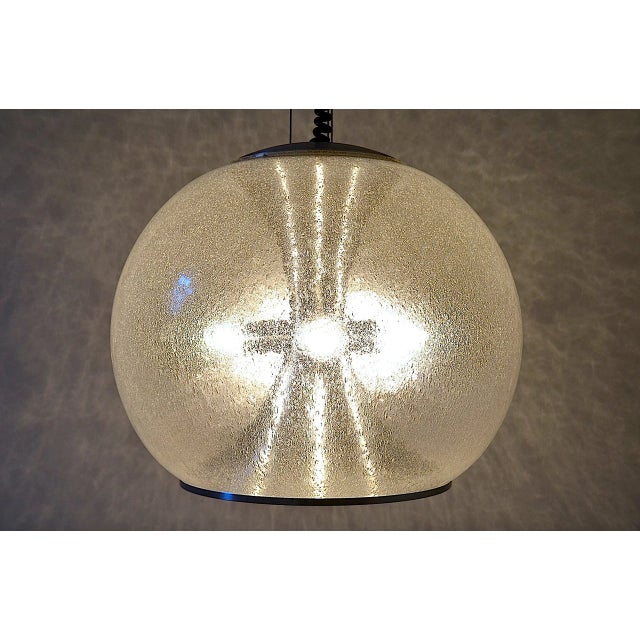 Bubbel pendant light from the German company Doria. The lamp features a very large sphere made of foam glass, inside an...