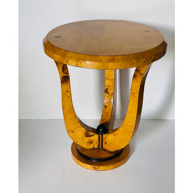 Elegant Art Deco round side table in Birds Eye veneer with ebonies accents.