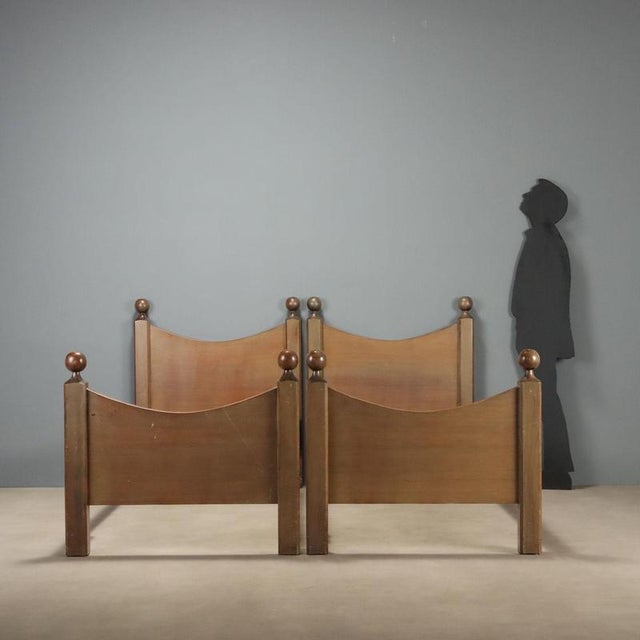 Two single beds from the 1960s in the style of Luigi Caccia Dominioni, crafted in wood with a natural finish that...