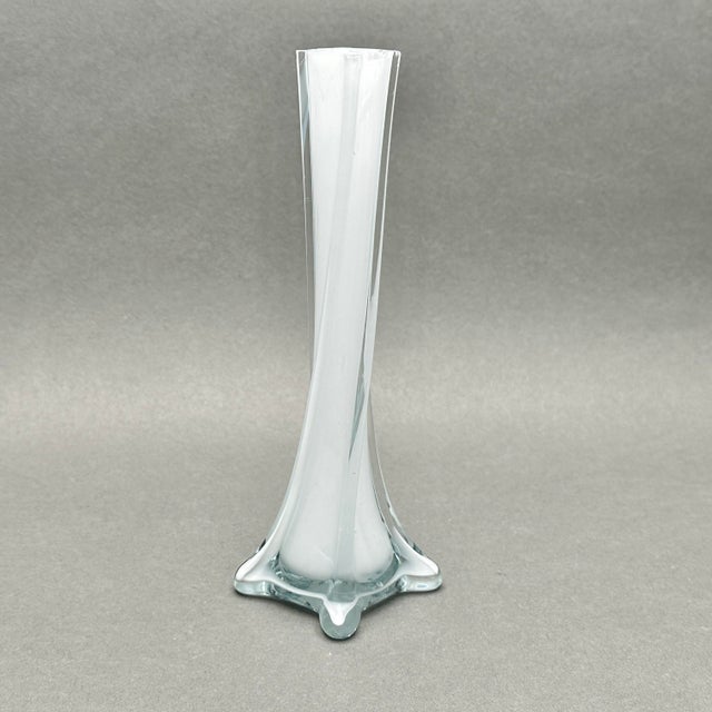 Vintage MCM twisted white cased clear glass bud vase. It has a cylindrical interior and squared exterior. It measures...