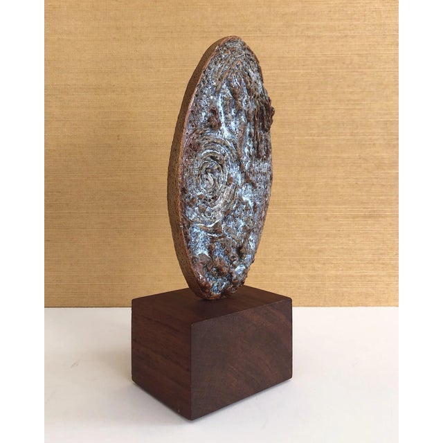Lovely little, abstract California-craft ceramic sculpture mounted on a wood stand. Oval in shape with a textured surface....