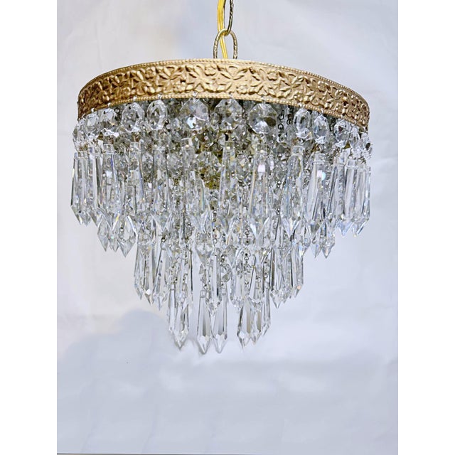 This is an Italian brass rim chandelier dressed with octagon bead and Plug cut crystals. It has 1 Edison base socket....