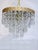 This is an Italian brass rim chandelier dressed with octagon bead and Plug cut crystals. It has 1 Edison base socket....