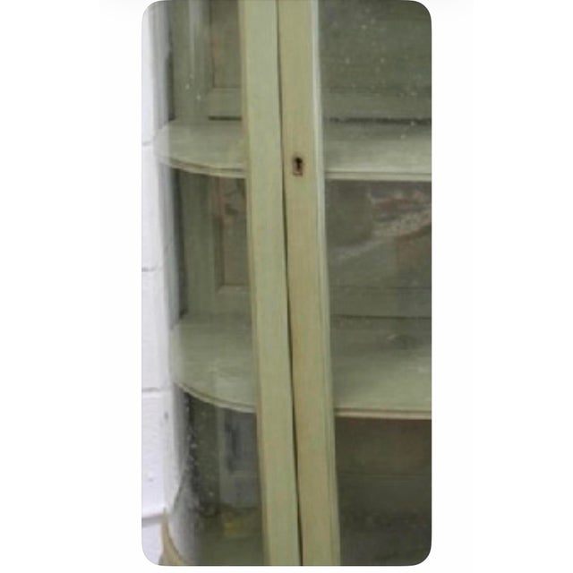Antique 1920 Green Display Cabinet. It has the original curved glass on the sides, wheels & key with original shelves too....