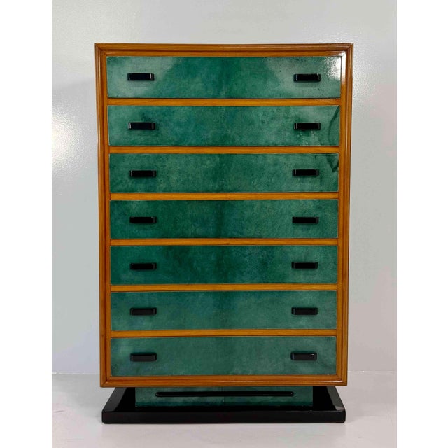 Refined Italian chest of drawers from the 1950s, distinguished by an elegant combination of emerald green parchment,...